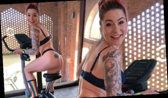 Lucy Spraggan cheekily poses in her underwear on an indoor bike