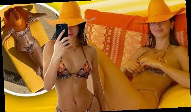 Kendall Jenner shows off her supermodel figure in a string bikini