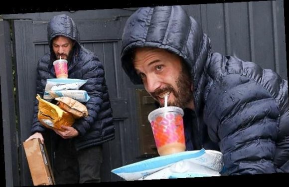 Ben Affleck juggles packages and Dunkin Donuts iced coffee in rainy LA