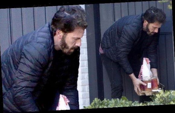 Ben Affleck emerges from his house to pick up a Dunkin' Donuts order