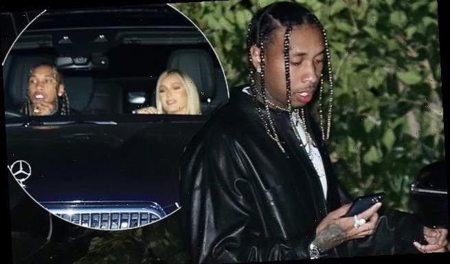 Tyga heads out for dinner with a female companion