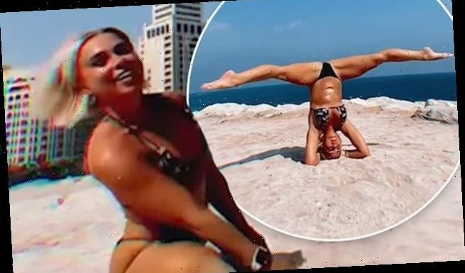 Gabby Allen does a headstand and SPLITS in a tiny bikini in Dubai