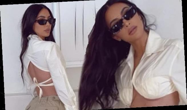 Kim Kardashian shows off her figure in a cargo pants and crop top