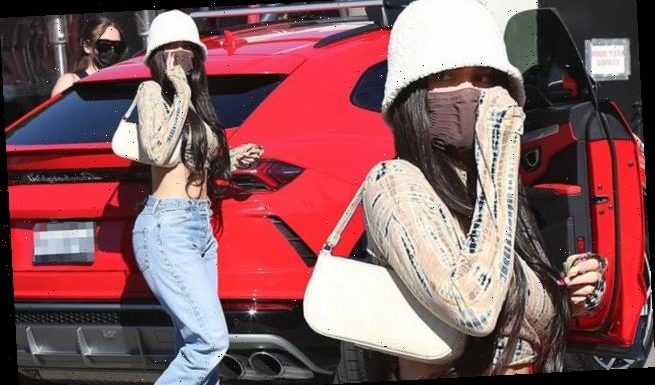 Kylie Jenner keeps it low-key in a bucket hat and a pair of blue jeans