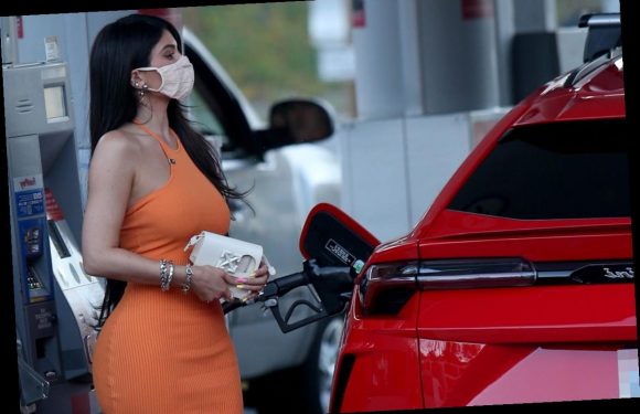 Kylie Jenner stuns in a figure hugging dress and pumps gas into her Lamborghini SUV after Kim Kardashian divorce filing