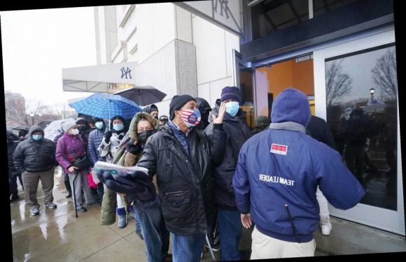 Crowds huddle together in Yankee Stadium COVID vaccine line