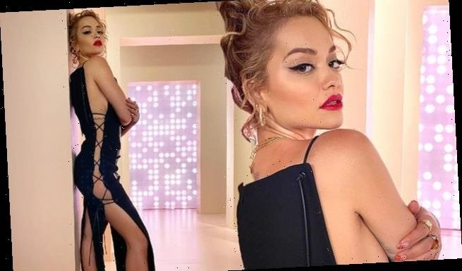 Rita Ora shows off her figure in a black midi dress for racy snaps