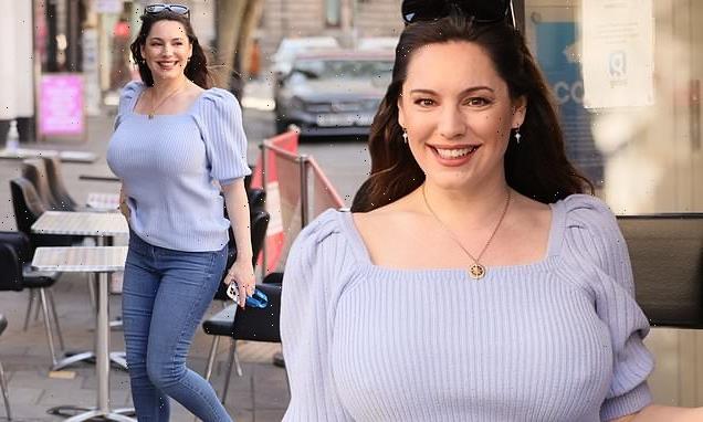 Kelly Brook looks casually chic in baby blue jumper and skinny jeans