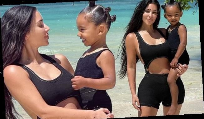 Kim cradles 'My twin forever!' Chicago, three, at beach hideaway