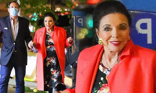 Dame Joan Collins stuns in a sleek floral print dress