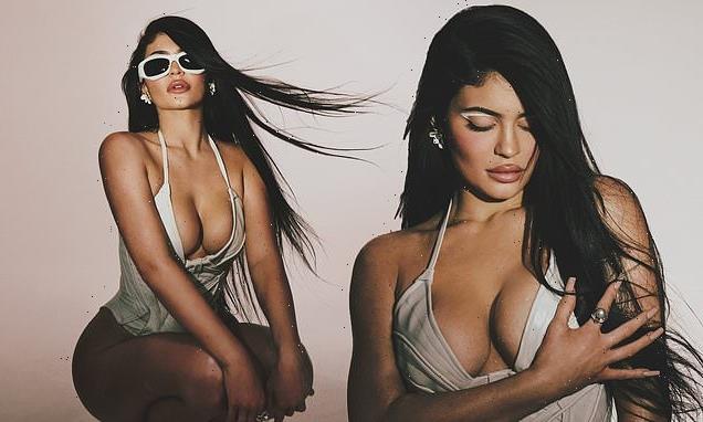 Kylie Jenner puts on a VERY busty in a white corseted swimsuit