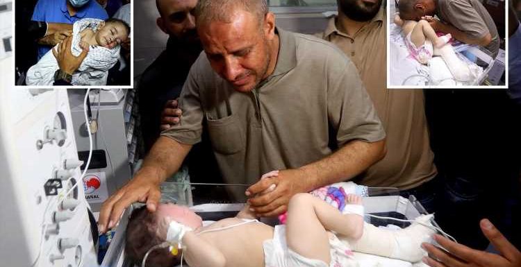 Moment dad reunited with baby boy who was pulled from rubble of Israeli air strike that killed mum and 4 brothers