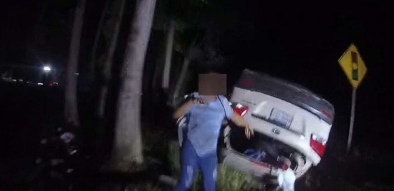 Video captures hero cop single-handedly lift overturned car off woman to save her life