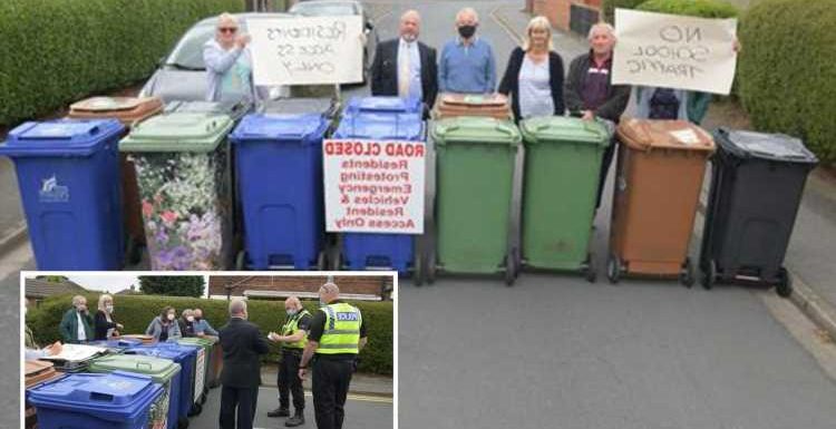 Furious residents build wheelie-bin blockade to stop school run parents dropping off kids