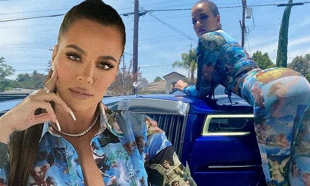 Khloe rocks a tied-up blouse as she poses in her blue Rolls-Royce