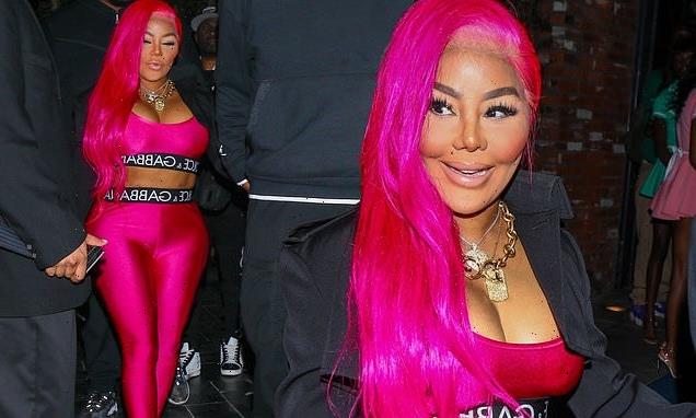 Lil' Kim puts on a VERY eye-popping display in a fuchsia pink crop top