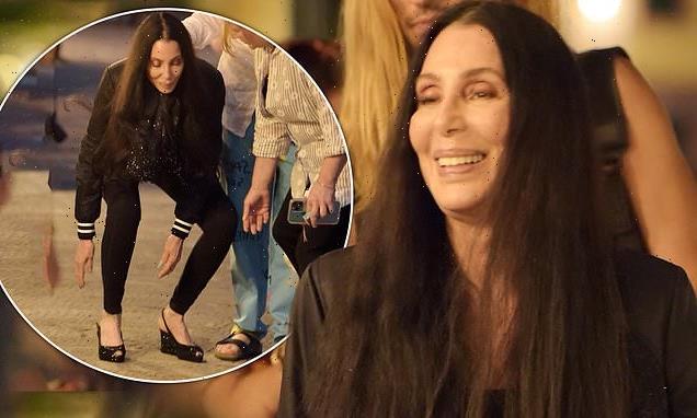 Cher, 75, struggles in her high heels as she steps out for cocktails