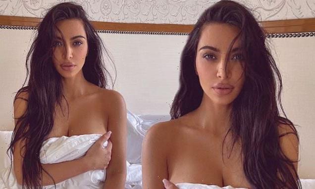 Kim Kardashian poses topless in bed for sultry snap