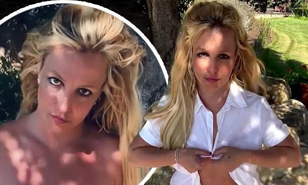 Britney unbuttons shirt then holds bare chest in backyard striptease