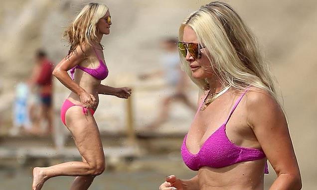 Caprice Bourret, 49, looks sensational in a purple and pink bikini
