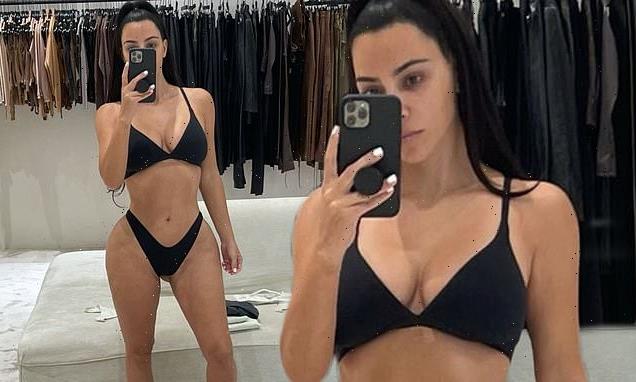 Kim Kardashian poses in black lingerie