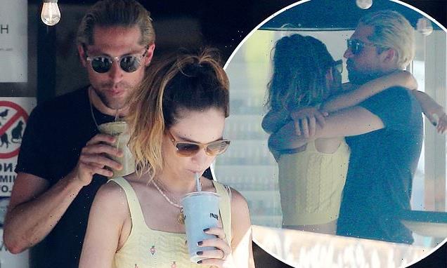Lily James cuddles beau Michael Shuman as they grab smoothies in LA