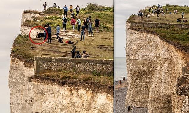 Visitors stand perilously close to edge of cliff at Beachy Head