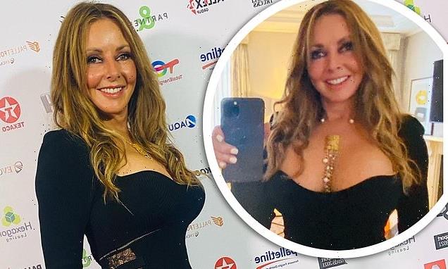 Carol Vorderman shows off her signature curves in a busty black dress