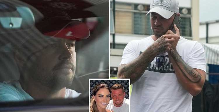 Katie Price's fiancé Carl Woods looks miserable as he takes a phonecall in Essex