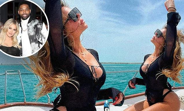 Khloe Kardashian showcases her curves while sunning on a yacht