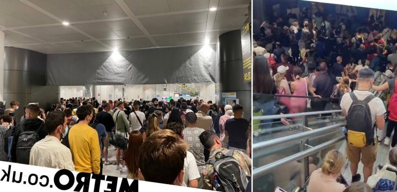 Passengers 'kick down barriers' at Malaga Airport in anger at long queues