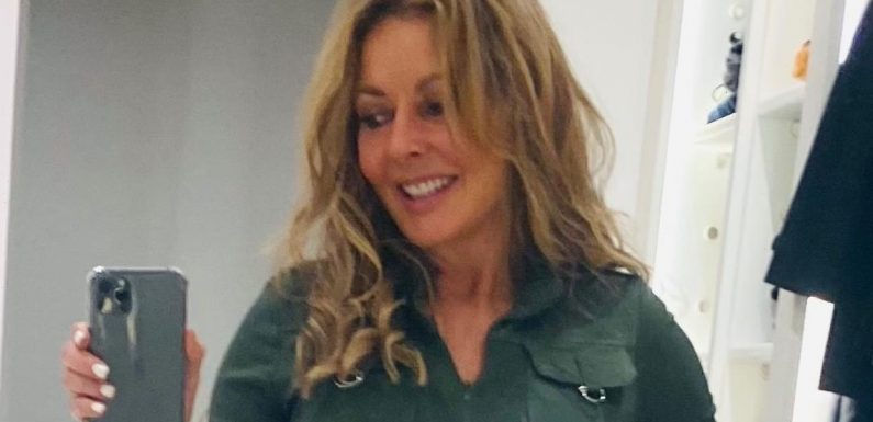 Carol Vorderman, 60, wows as she shows off her curves in a green jumpsuit and leather boots
