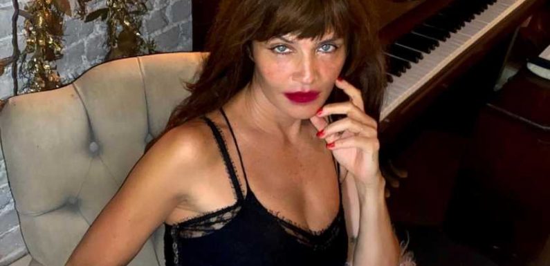 Danish supermodel Helena Christensen poses in black lace dress that sold out in seconds