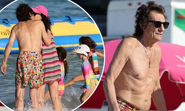 Rolling Stones rocker Ronnie Wood plants a kiss on wife Sally