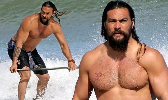 Jason Momoa exhibits his toned chest as he goes surfing in Hawaii