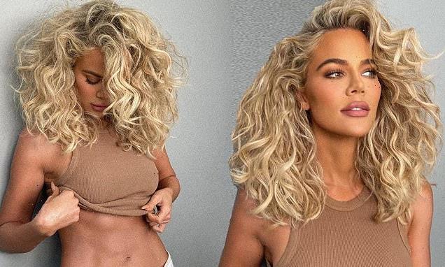 Khloe Kardashian shows off rock hard abs in a tiny beige tank top
