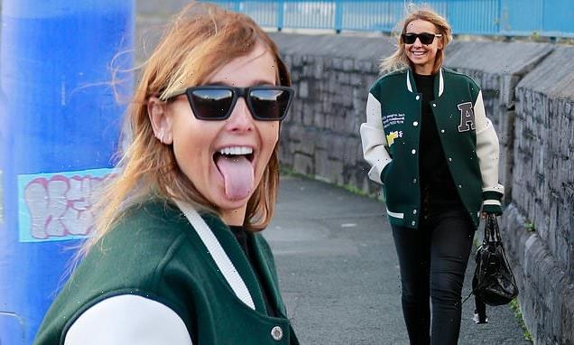 Louise Redknapp smiles wide as she takes a stroll around Plymouth