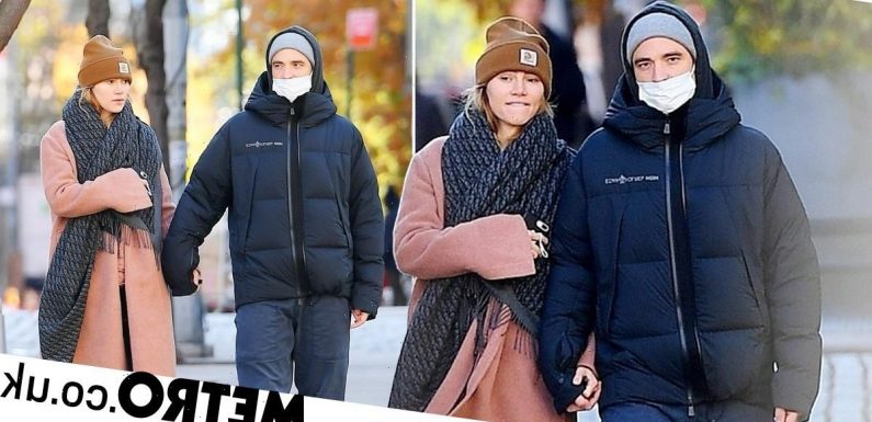 Robert Pattinson and Suki Waterhouse look as smitten as ever on romantic walk
