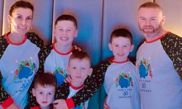 Wayne and Coleen Rooney pose in Christmas pyjamas with four sons