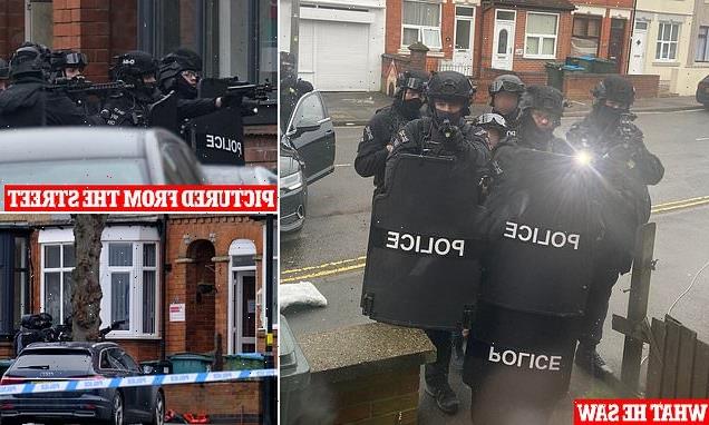 Armed father posts photo of police camped outside during two-day siege