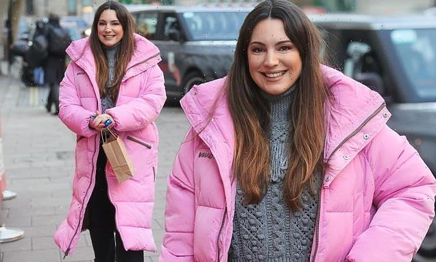 Kelly Brook wears a playful pink coat and Prada loafers to Heart Radio