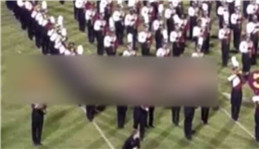 US school marching band spells out racial slur during half-time show at American football match sparking outrage