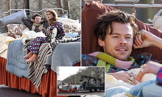 Harry Styles climbs into a BED to film his new music video