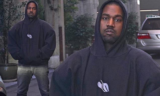 Kanye West rocks hoodie and black boots as he and Vic Mensa greet fan