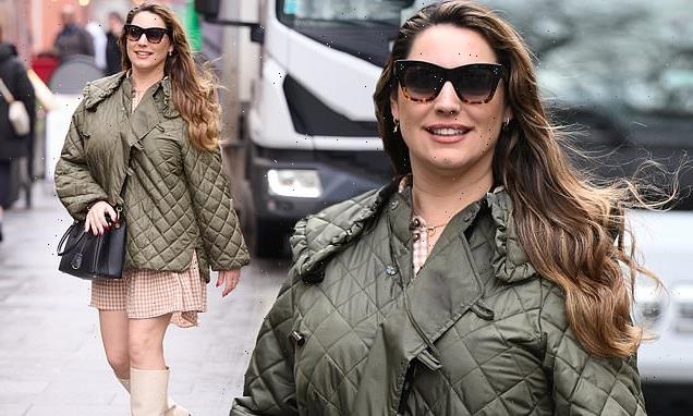 Kelly Brook looks leggy in a gingham mini dress and knee high boots