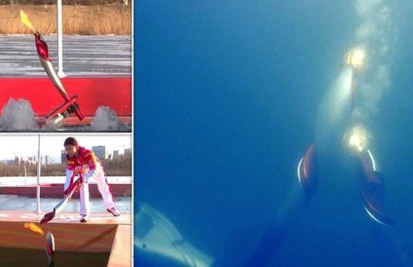 Olympic flame passed UNDERWATER between two robots in a world first