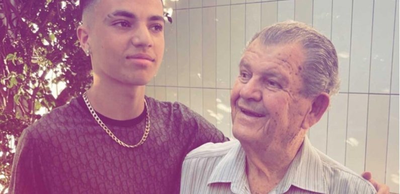 Junior Andre poses with his grandad after dad Peter's tearful reunion with his parents in Australia