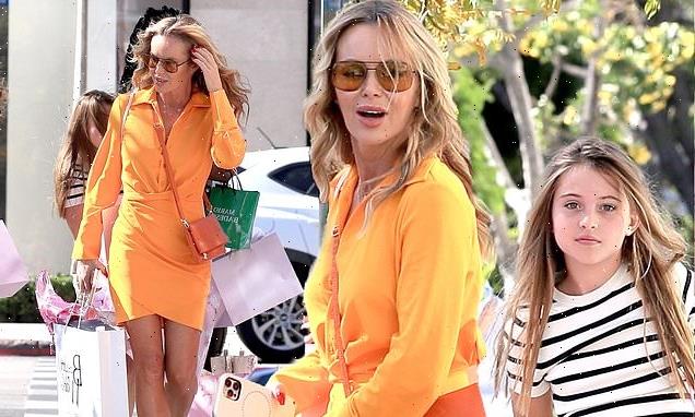 Amanda Holden stands out from the crowd in bold orange dress