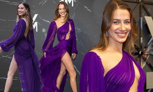 Brad Pitt's ex Nicole Poturalski stuns in a thigh-high split gown