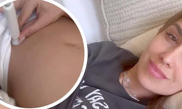 Hilaria Baldwin uses a fetal doppler to listen to her baby's heartbeat